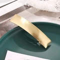 Minimalist rectangular gold metal hair clip with brushed texture on a green plate - Gold Brushed (C3304)