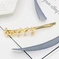 Minimalist golden alloy hair clip featuring a stylish happy word script design - Gold Happy