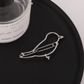 Close-up of minimalist silver bird hair clip with polished metallic finish on tray - Silver (B9223)