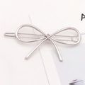 Minimalist silver alloy bow hairpin featuring a sleek metal wire design on a display card - Bow Shape (F2104) / Silver