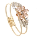 Detail of gold double-layer bracelet with champagne crystal plum flower and pavé rhinestones - Champagne