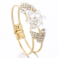 Detailed macro view of gold hinge bracelet featuring crystal floral petals and rhinestones - White Crystal
