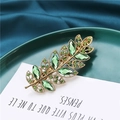 Detail of leaf hair clip with green crystals and gold base on elegant silk - Light Green (B3522)
