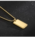 Macro shot of gold dog tag pendant on sleek snake chain with high polish finish - Gold Pendant Only
