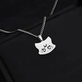 Minimalist silver stainless steel cat face pendant necklace on a black leather surface - Crying Cat