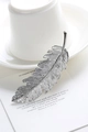 Elegant silver feather hair clip with intricate brushed texture on white ceramic - Silver (B8402)