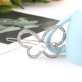 Macro shot of butterfly hair clip with white crystals and central pearl on silver alloy - Thick Silver / Style Seven (B8102)