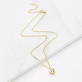 Minimalist gold necklace with a round sparkling solitaire cubic zirconia on white marble - Gold (D3110)