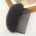 Close-up of a black hair styling tool featuring a plastic comb and volumizing sponge pad - Black Large (N5301)