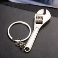 Mini silver adjustable wrench keychain with functional worm gear on black leather background - Adjustable Wrench (D1420)