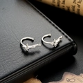 Silver butterfly ear cuffs with sparkling zircon stones on black leather background - Silver