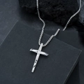 Silver cross pendant necklace with geometric textures and box chain on black rock - Steel