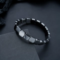 Macro shot of polished square hematite beads showing smooth facets and metallic luster - Glossy Black Square Style (S528-A)