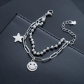 Close-up of silver layered bracelet with star and smiley face pendants on black leather - Smiling Face Star Style (S537-A)