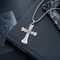 Macro detail of a vintage silver cross necklace with crown design on a black book - Crown Cross Style (L845-A)