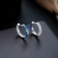 Detail of silver hoop earrings with micro-set zircons and deep blue enamel waves - Blue Earrings (X1091-B)