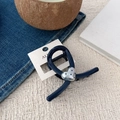 Detail of dark blue hair claw clip with silver heart pattern on a card holder - Heart Polka Dot Y Claw