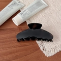 Glossy coffee brown acetate hair claw clip for thick hair displayed on a wooden table - Seven Teeth Claw / Black
