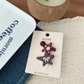 Close-up of star-shaped red polka dot and black-red checkered hair clips on card - Red Bow Star Woven Side Clip