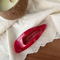Detail of a large 11.5cm vibrant red glossy hair claw clip on white lace embroidery background - Red