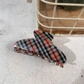 Macro view of classic red and black plaid hair claw clip with smooth acetate finish - Khaki Base Black White Red Stripe