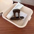 Detail view of a beech brown hair claw clip placed inside an eco-friendly storage box - Beech Brown - Hat Style Hair Claw