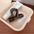 Detail of elegant dark brown glossy hair claw clip in a minimalist lifestyle setting - Beech Brown - Straight Bow Hair Claw (8cm)