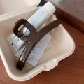 Detail of elegant dark brown matte hair claw clip inside a minimalist gift box - Beech Brown - Circular Hollow Hair Claw