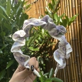 Detail of ruffled floral headband with purple flowers and white scalloped lace edges - Headband / Purple