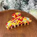 Iridescent mermaid acetate hair claw clip with colorful marble pattern on wooden tray - Tomato Fun