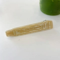 Detail der kreativen Haarspange in Zahnpastaform mit Goldglitzer und organischem Text - Beige Glitzer Handcreme-Entenschnabelclip