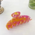 Detail view of pink and orange marble floral acetate hair claw clip for elegant hairstyling - Large / Pink Yellow Feather