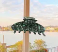 Detailed view of the large dark green tortoiseshell acetate hair claw clip with glossy finish - Clear Water