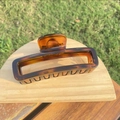 Large tortoiseshell pattern hair claw clip with amber gradient displayed in natural light - approx 11.8cm / Extra Large Glossy Light Tortoiseshell Bottle