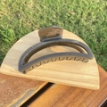 Macro detail of a large grey crescent hair claw clip on wooden stand with garden background - 12cm / Dark Gray Crescent