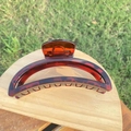 Detailed macro view of amber tortoiseshell large hair claw clip with strong spring - 12cm / Bright Reddish Brown Crescent