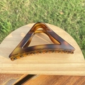 Macro detail of large triangle hair claw clip with dark amber tortoise pattern on wood - approx. 11.5cm / Matte Light Tortoiseshell Gradient Triangle
