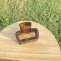 Detailed view of large tortoise shell hair claw clip with amber gradient texture and hollow design - Approx 5.5cm / Small Matte Light Tortoiseshell Bottle Shape