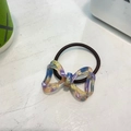 Detail of a handmade marble patterned acetate bow hair tie with brown elastic band - Purple Ombre Marble Bow Hair Tie