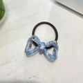 Detail of blue marble acetate bow on high-elasticity brown braided hair tie accessory - Blue Floral Marble Bow Hair Tie
