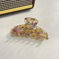 Detail view of large acetate claw clip with colorful floral pattern on white texture - Yellow Floral / 10.5cm