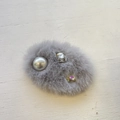 Pasador de pelo gris peludo con perla y cristales sobre un fondo de madera blanca - Gris Plata