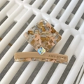 Detail of amber acetate hair claw clip featuring rhinestone square and Amy Bear brand logo - Khaki