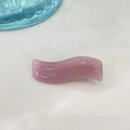 Close-up of pink jelly-textured wavy hair clip with gold logo detail on white background - Pink Jelly
