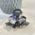 Detailed close-up of acetate bow hair claw clip with golden brand logo on a ceramic plate - Medium Claw Clip (Approx 8.2cm) / Grey Purple Iridescent