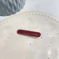 Elegant deep red acetate rectangular hair clip with gold label on a minimalist ceramic plate - Straight Duckbill Clip / Red