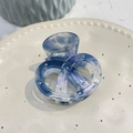 Blue marble acetic acid pretzel hair claw with silver studs on elegant ceramic dish - Blue