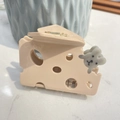 Detail of cheese-shaped hair claw clip with a cute mouse accent on marble surface - Pink Cheese Style