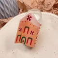 Detail of Christmas gingerbread house hair claw clip on cream ceramic plate - Gingerbread House