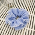 Detailed view of the blue and white checkered plaid fabric scrunchie with ruffled edges - Blue Plaid Scrunchie